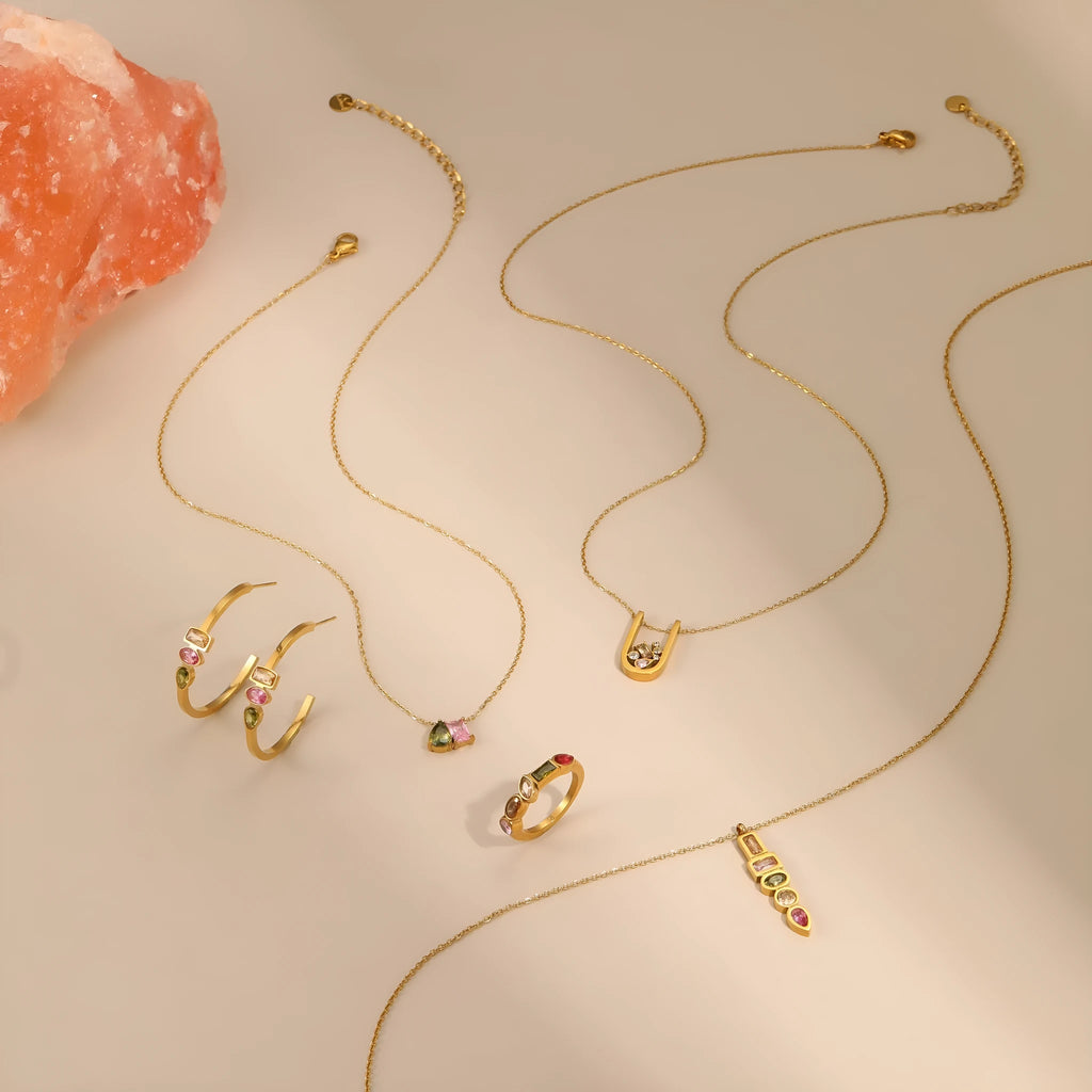 Geometric gold plated jewellery set with zircon accents including necklace, ring, and earrings