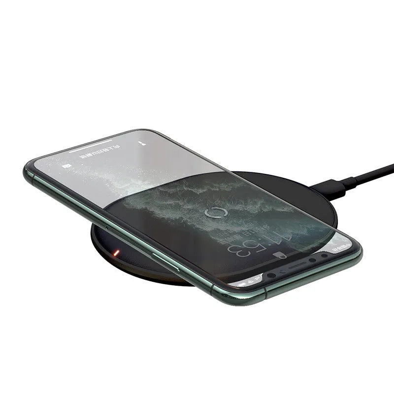 Baseus rough-textured 15W wireless charging pad for mobile phones in black on a desk.