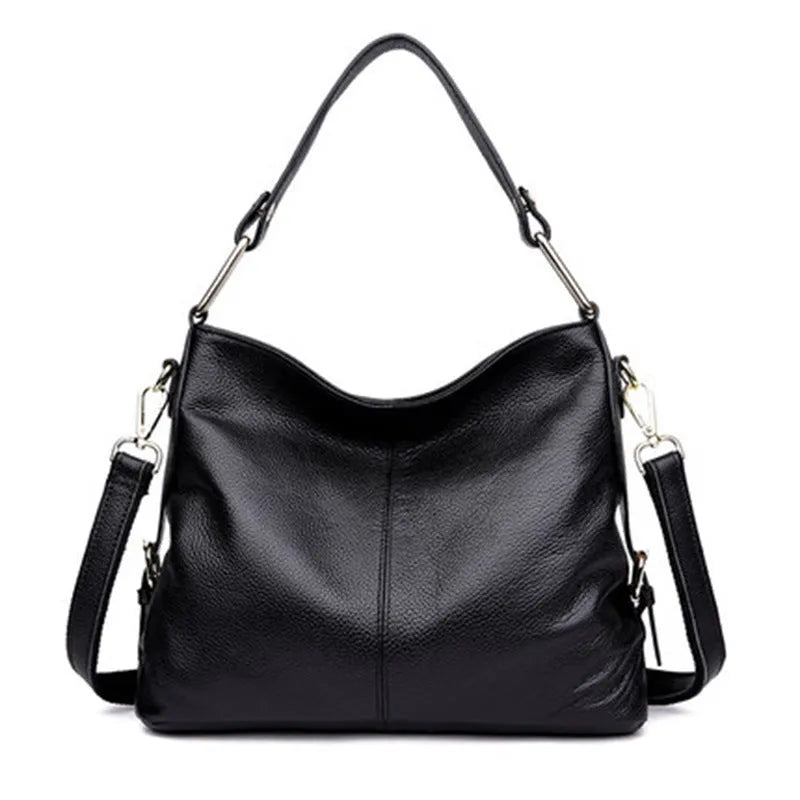 Genuine leather vertical square crossbody bag in black showing outer pocket and structured shape.