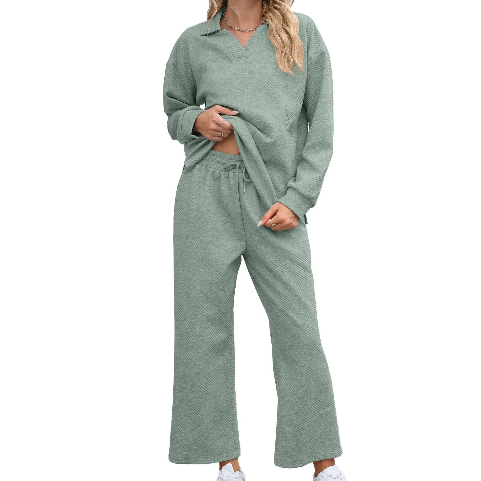 Women's geometric patterned knitted suit set with lapel sweater and cropped trousers in multiple colours.