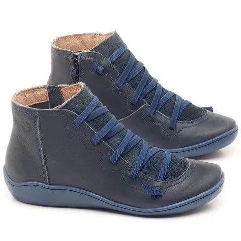 Women's casual flat ankle booties with a wedge heel and round toe in various colours.
