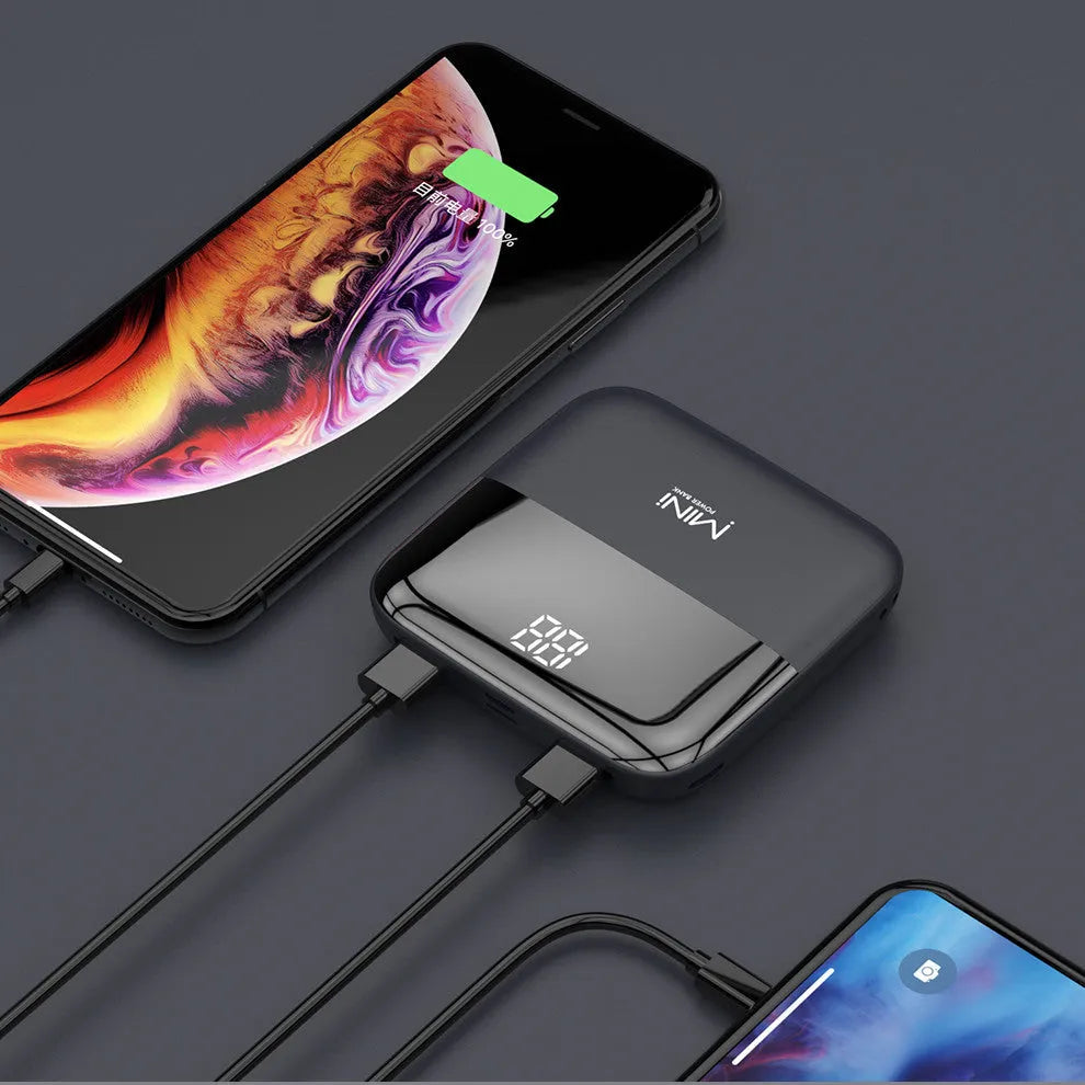 White portable power bank with digital display showing battery percentage and two USB ports.