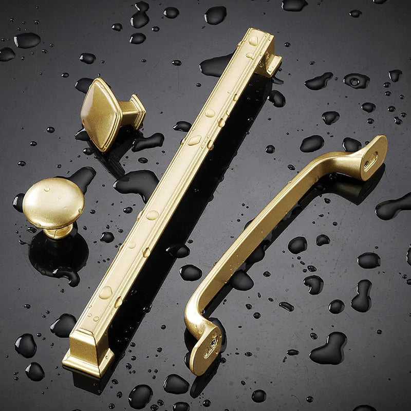 Modern gold aluminium alloy single-hole cabinet handle with T-shape design.