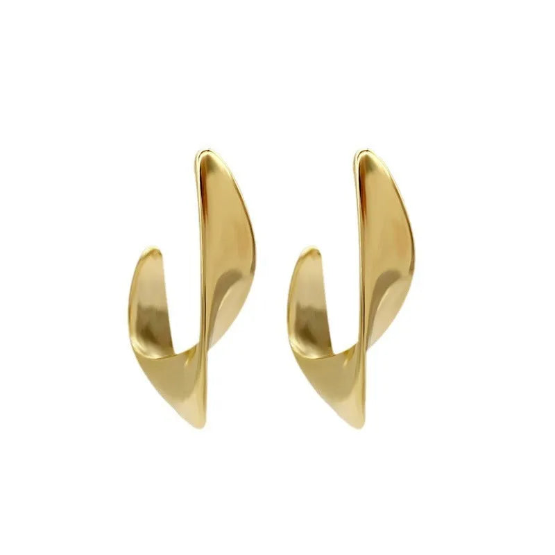 A pair of round, twisted geometric metal earrings with a gold electroplated finish.
