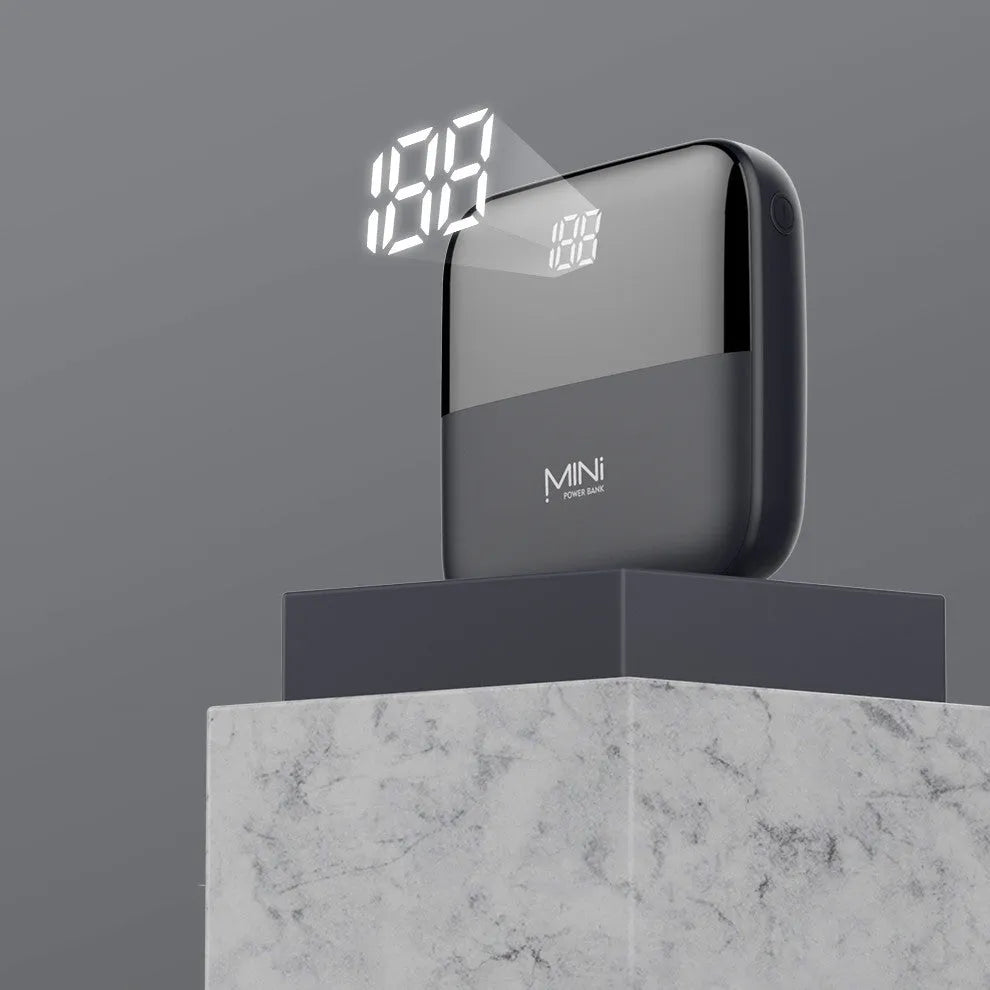 White portable power bank with digital display showing battery percentage and two USB ports.