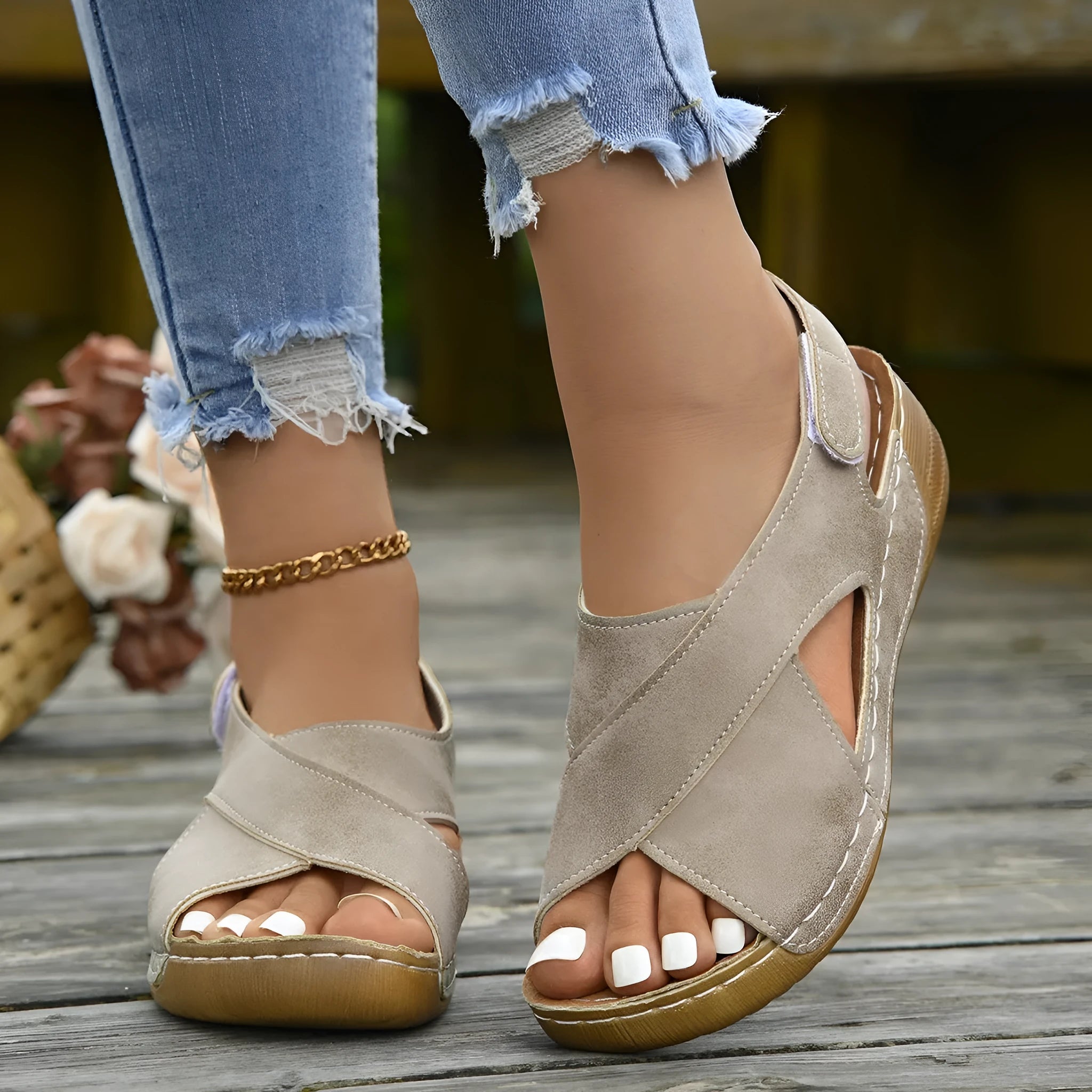 Women's brown platform Roman sandals with skirted ankle strap and Velcro fastening on a white background.
