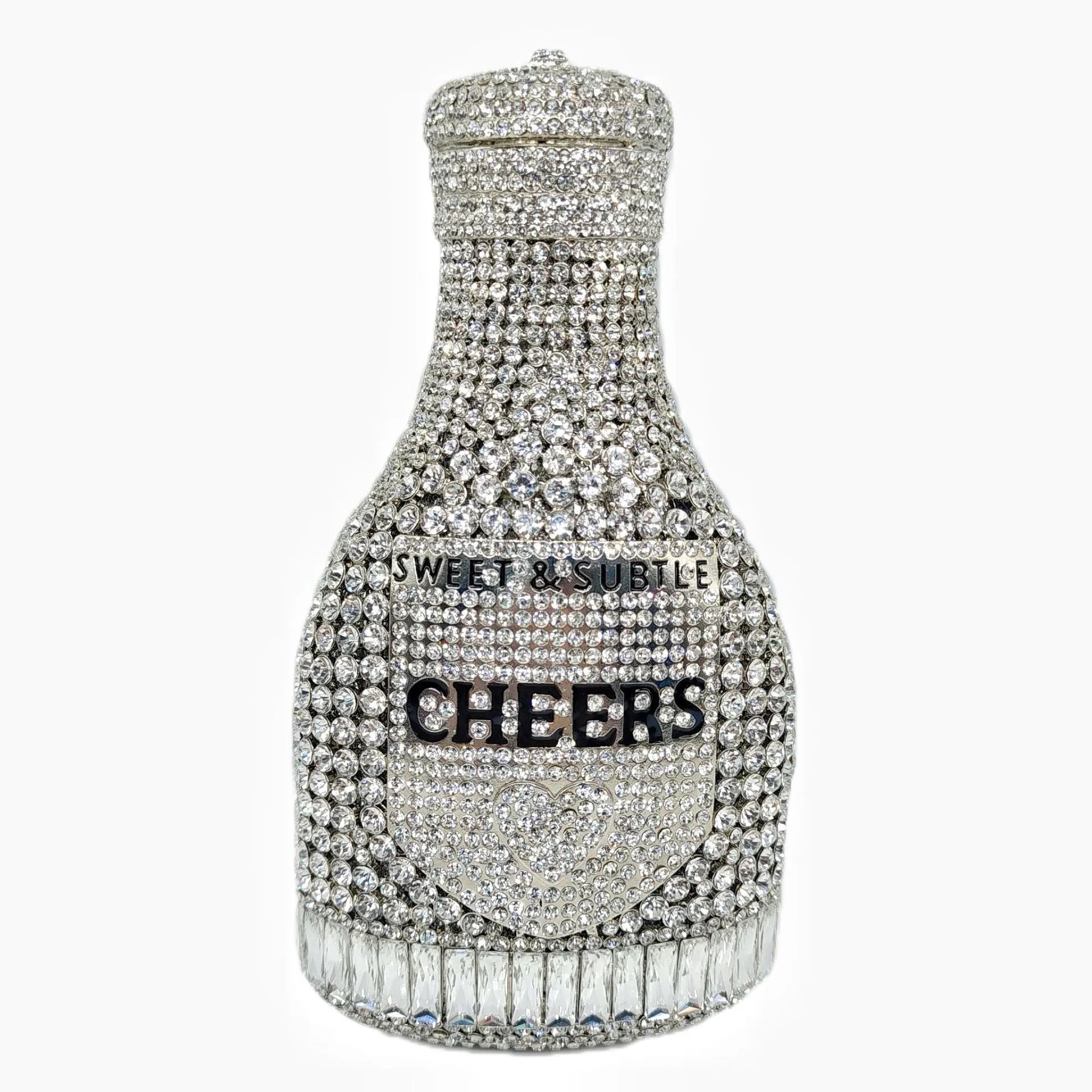 Gold hard-shell champagne bottle shaped evening clutch with rhinestones on a table.