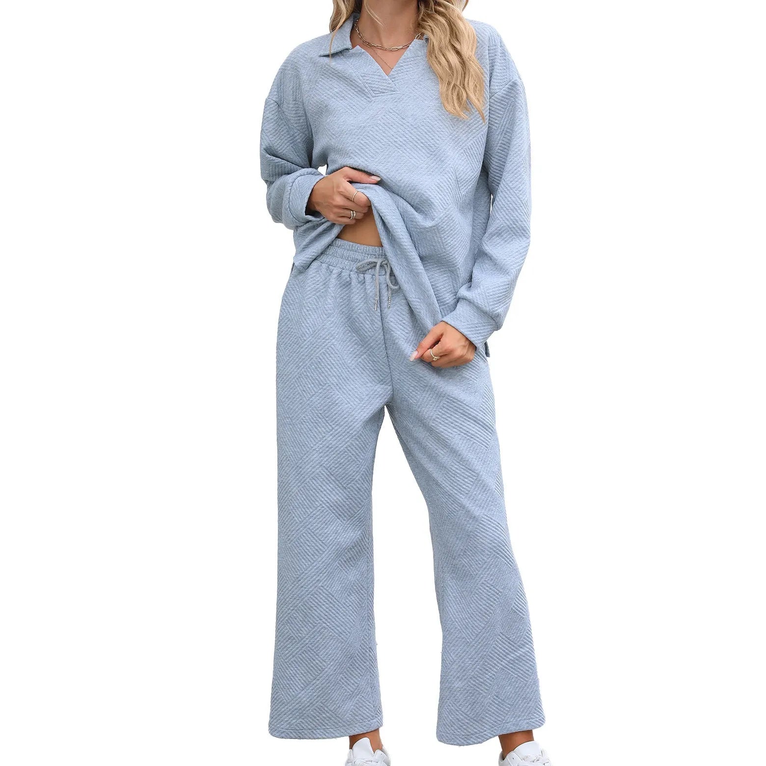 Women's geometric patterned knitted suit set with lapel sweater and cropped trousers in multiple colours.