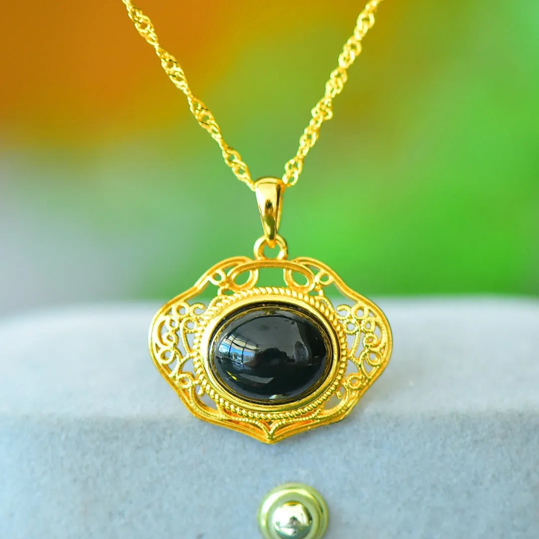 Flat gray and ink blue Hetian Jade pendant with copper inlaid decoration on a necklace.