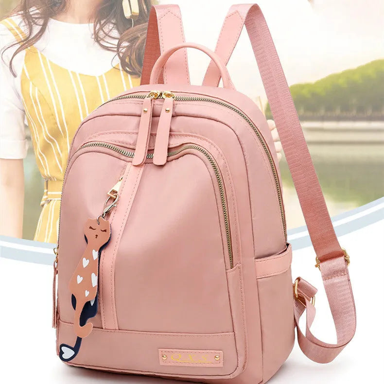 Black and pink casual nylon backpack with double straps, soft handle, and square vertical shape