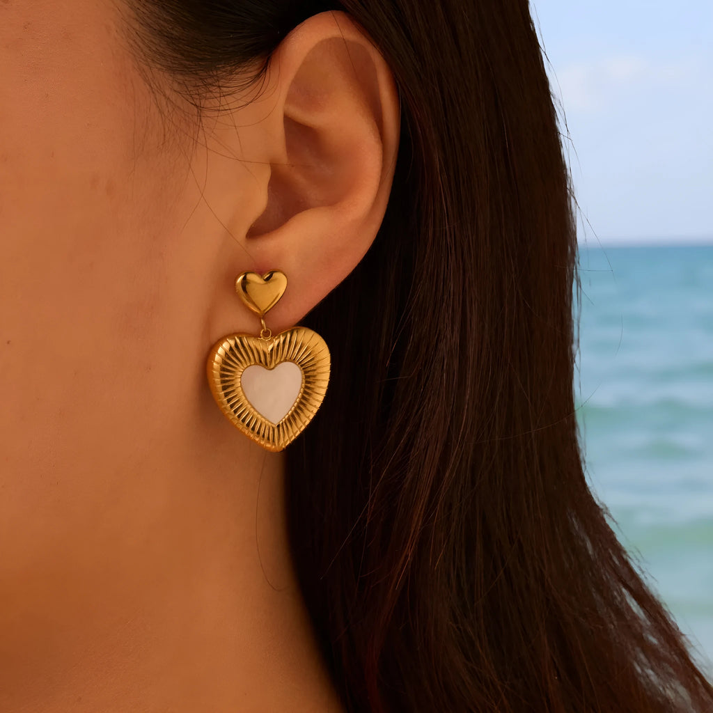 Gold heart-shaped stainless steel stud earrings for women with a love motif.