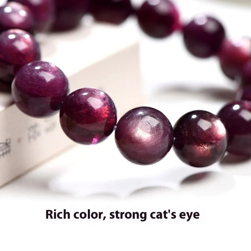 Natural purple lepidolite crystal bracelet with round polished beads on a wrist.