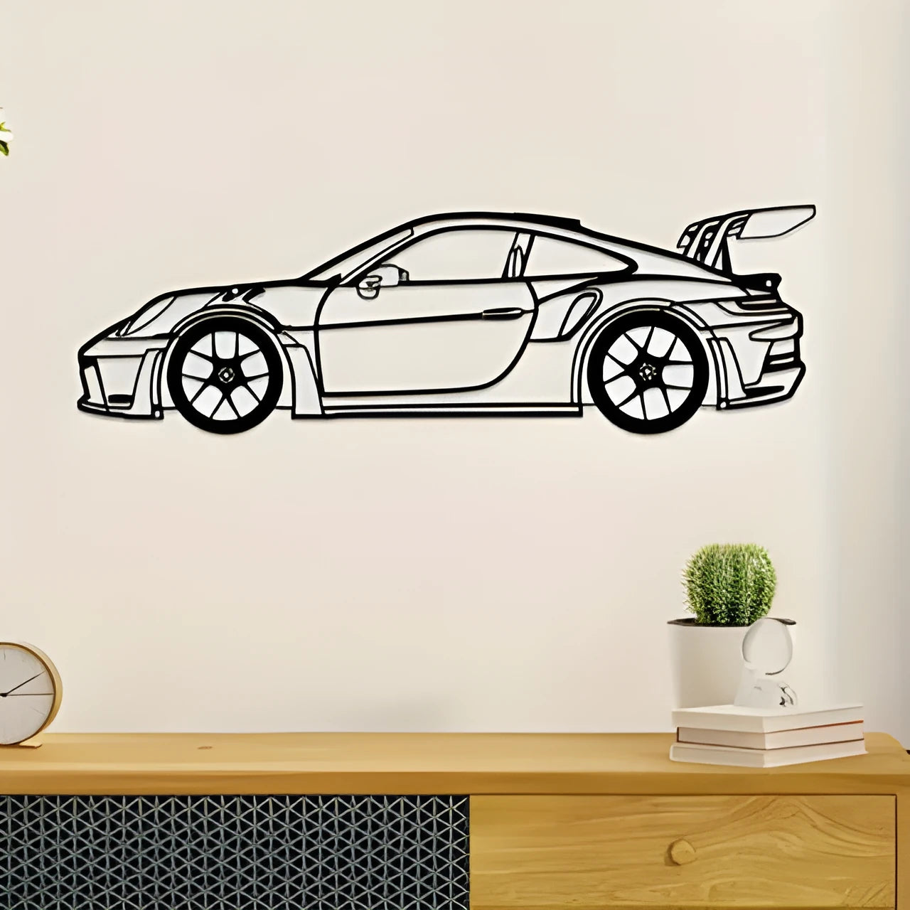 Black iron metal sports car wall art decoration against a wall