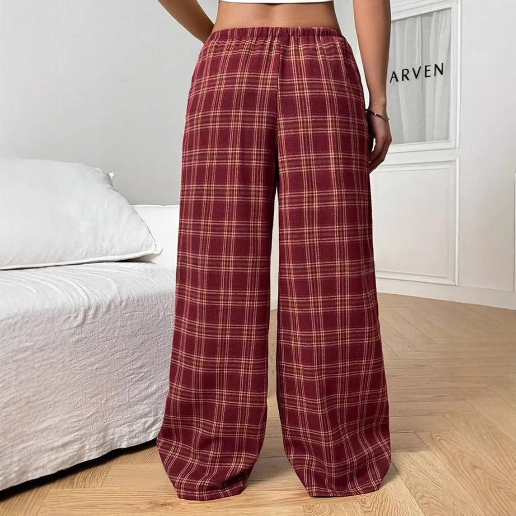 Red women's loose fit plaid trousers with drawstring waist and pockets on a mannequin.