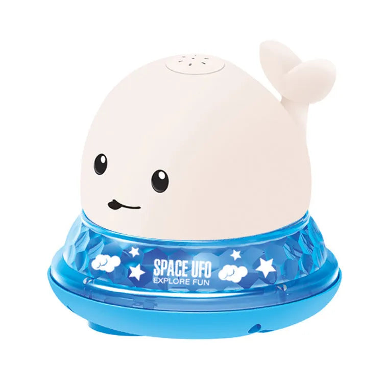 Whale-shaped electric bath toy spraying water with flashing lights, on a blue base.