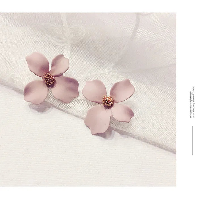 Women's flower stud earrings with electroplated pink or white finish on alloy construction