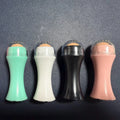 Volcanic stone facial roller for oily skin control in black, green, pink, or white colours.