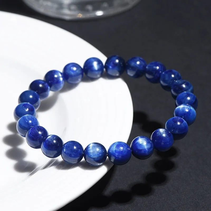 A blue crystal ball bracelet with a geometric shape and traditional Ruyi design elements.