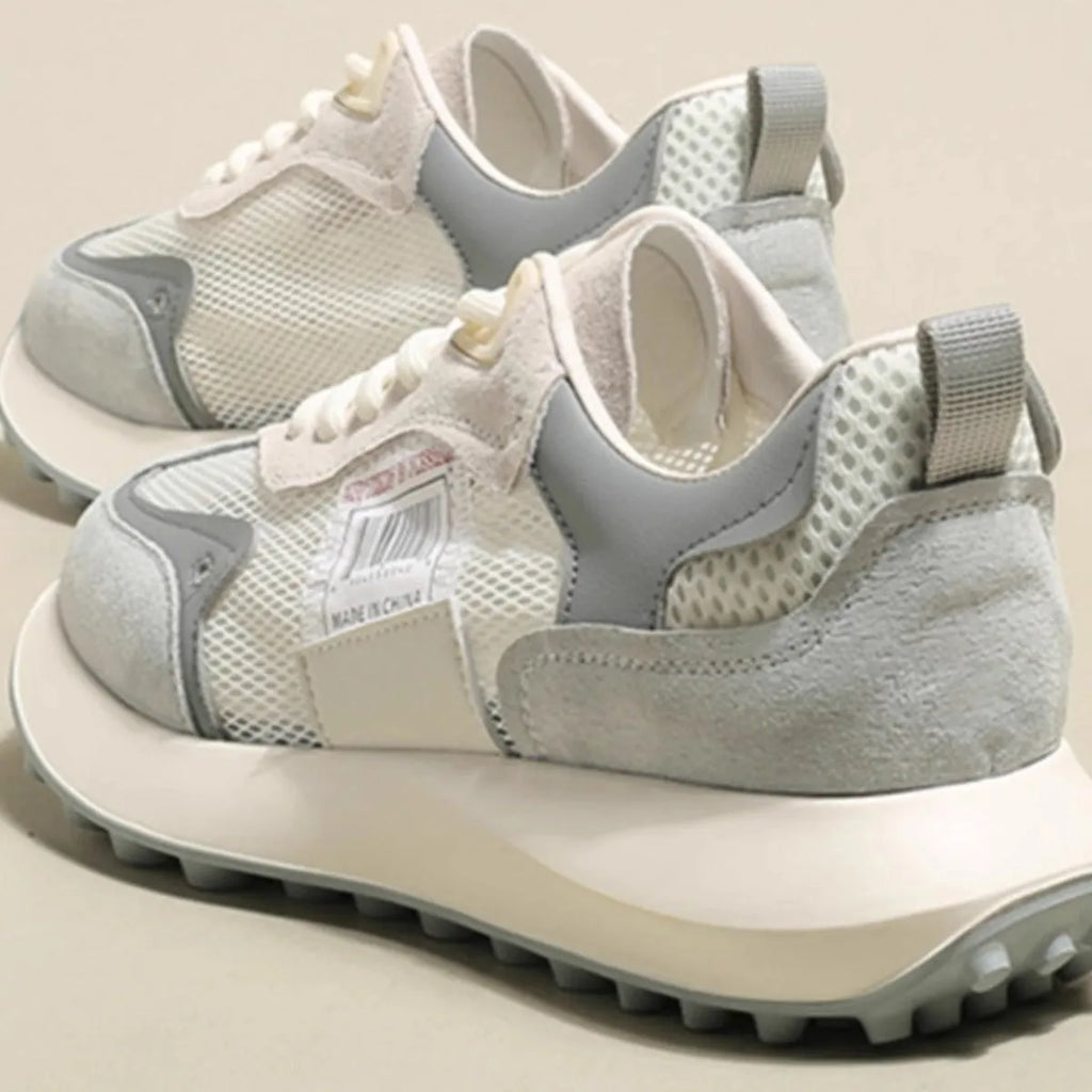 Women's grey retro sneaker with low-top design, mesh lining, and rubber sole