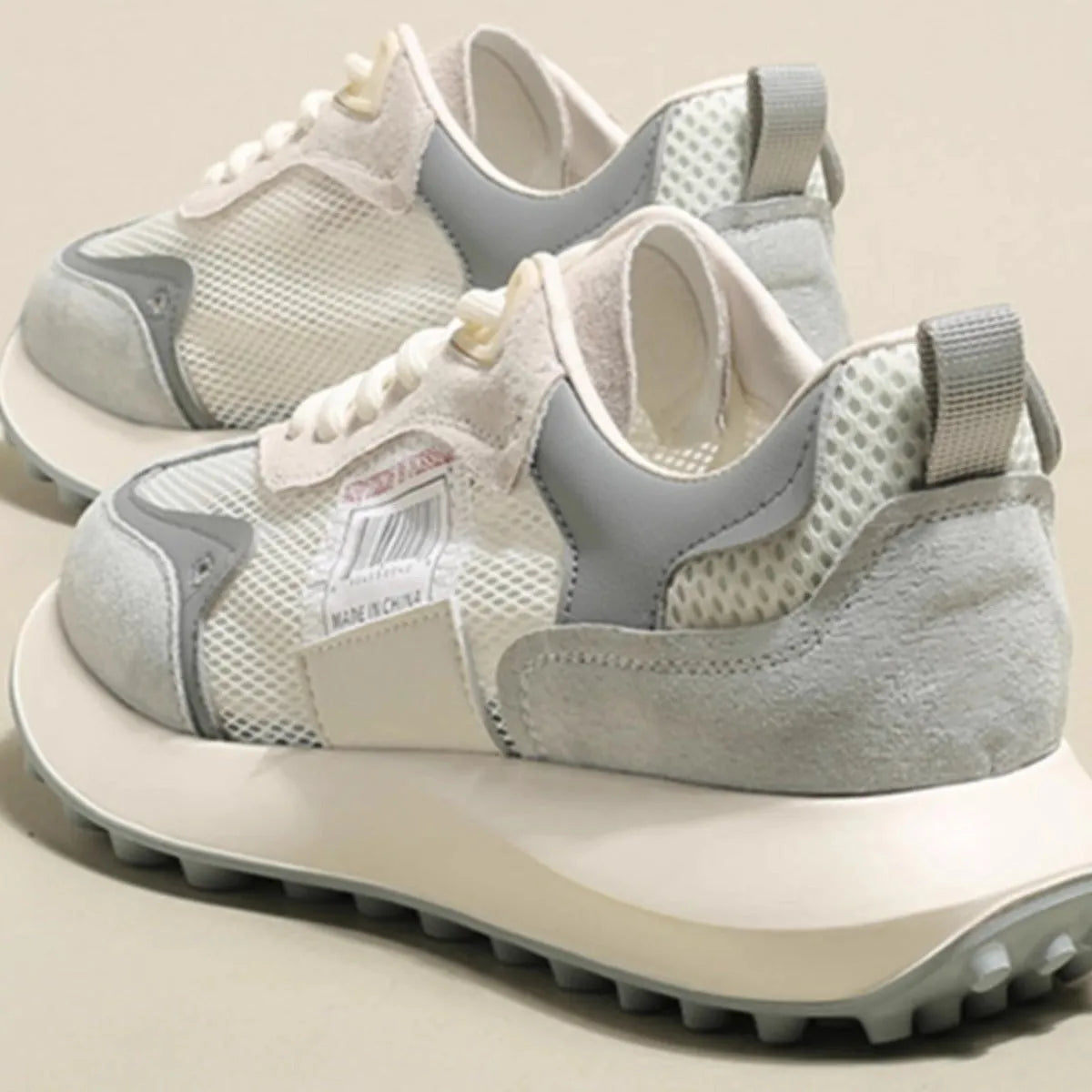 Women's grey retro sneaker with low-top design, mesh lining, and rubber sole