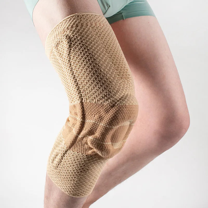 Adult sports knee pads in black and blue colour, shown on a knee for size reference.