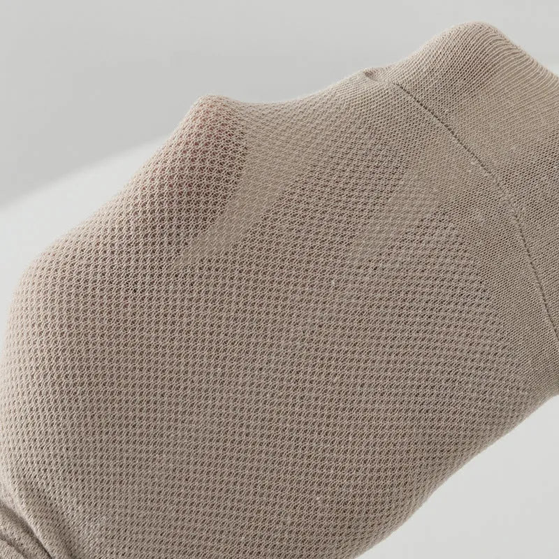 Solid colour low-cut polyester boat socks for men on a neutral background.