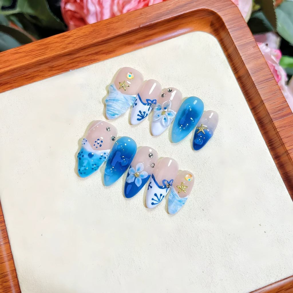 Blue hand-painted carved summer ice transparent plastic fake nails set in sizes XS, S, M, L.