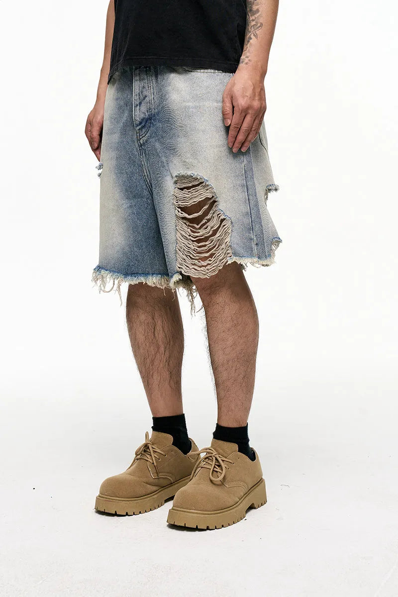 Light blue men's baggy denim shorts with a wide leg and mid waist on a plain background.