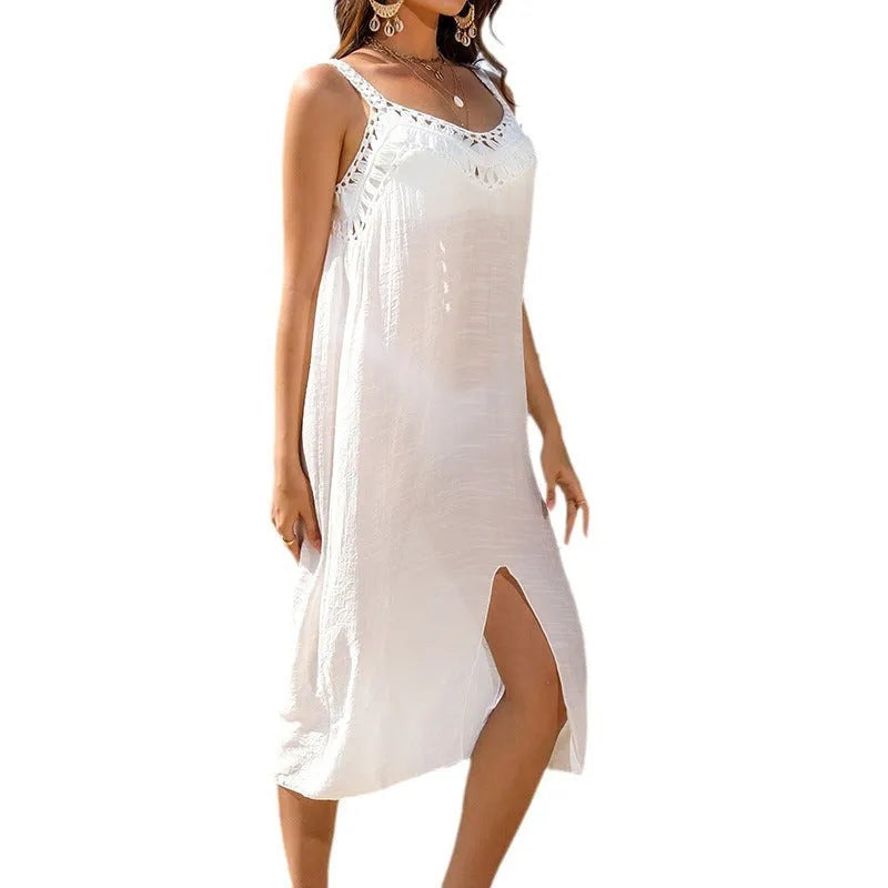 White women's beach dress with hollow crocheted detail and bottom slit.