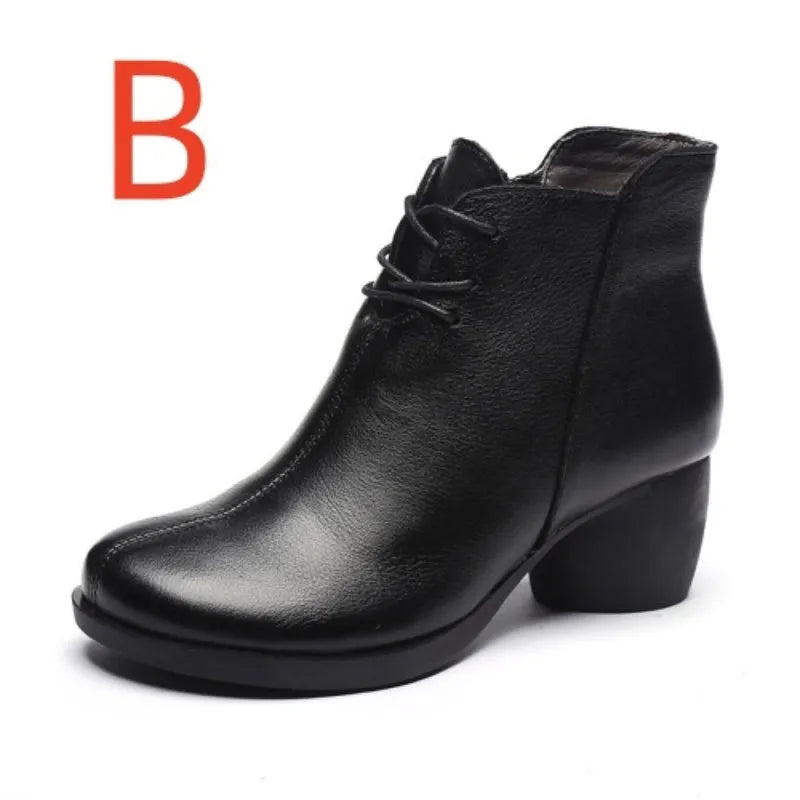 Women's brown leather Martin boots with a thick block heel and round toe on a wooden floor.