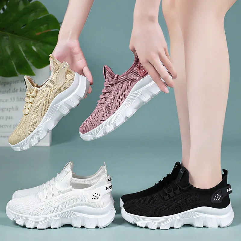 Women's white Flyknit sneaker with thick sole and lace-up front, shown on a neutral background