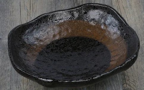 Japanese ceramic sashimi bowl with irregular shape and floral decoration pattern