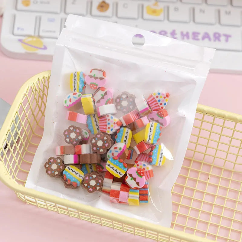 50 small colourful cartoon erasers in a pearlescent bag showing fruit, animal, cake, and Halloween themes.