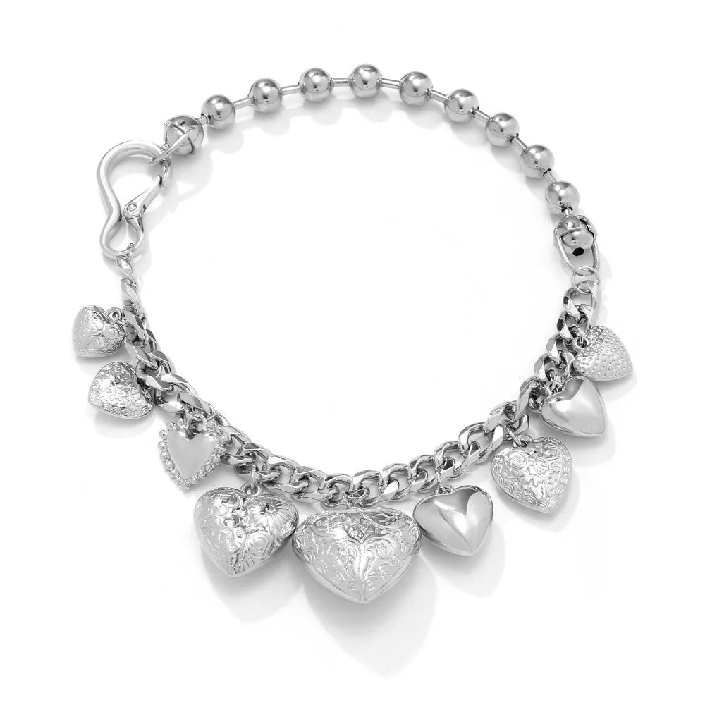 Exaggerated carved heart pendant necklace in gold or white K on an adjustable metal chain.