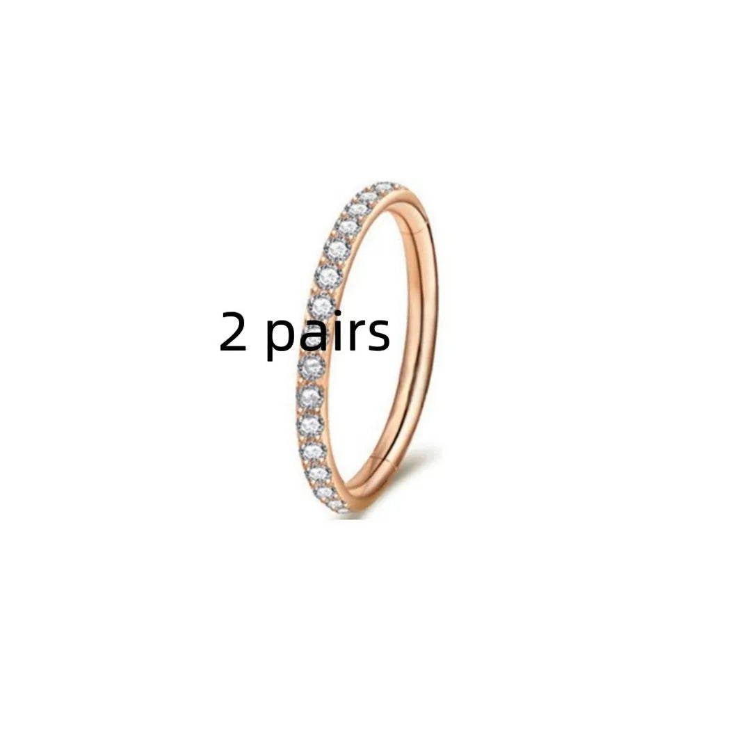 Stainless steel seamless nose rings showing steel, gold, rose gold, and black electroplated finishes with round design