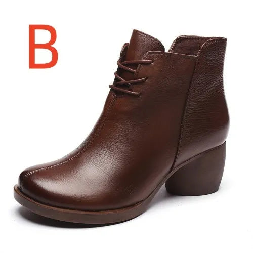 Women's brown leather Martin boots with a thick block heel and round toe on a wooden floor.