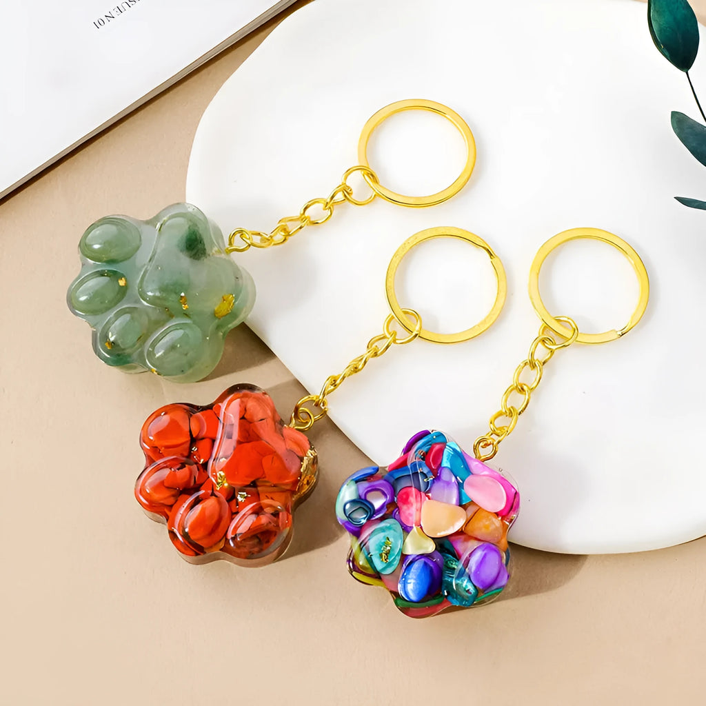 Natural crystal cat's paw keychain pendant in various gemstone colours including pink, red, blue, and green