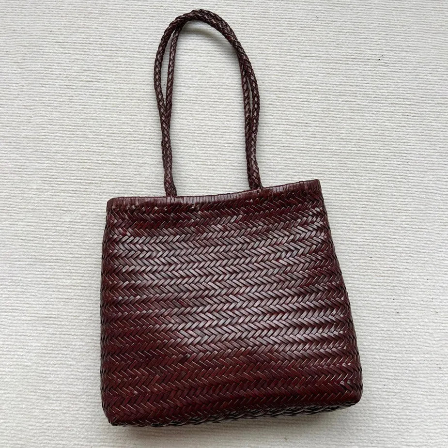 Brown handmade cowhide leather shoulder bag with woven tote design and three-dimensional pocket