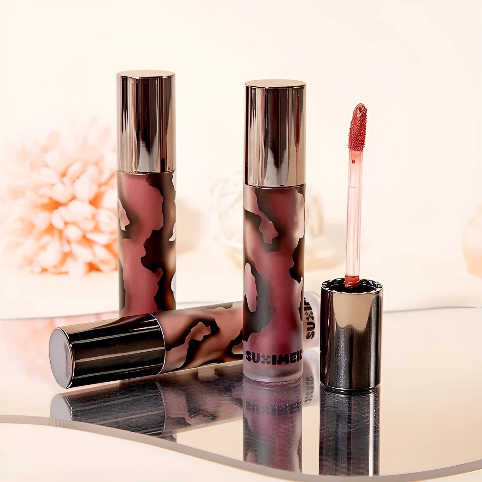 Matte lip mud lipstick tube showing five colour shades including orange brown coffee and cool grey
