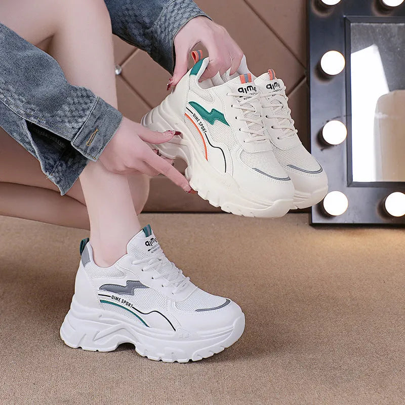 White women's low-top dad shoes with cross straps and lace-up front, showing round toe and rubber sole.