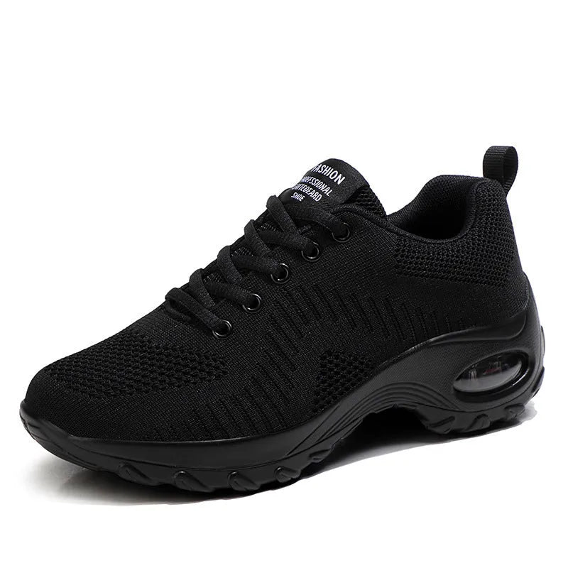 Women's black mesh sneakers with round toe and front lace-up closure showing flat heel design