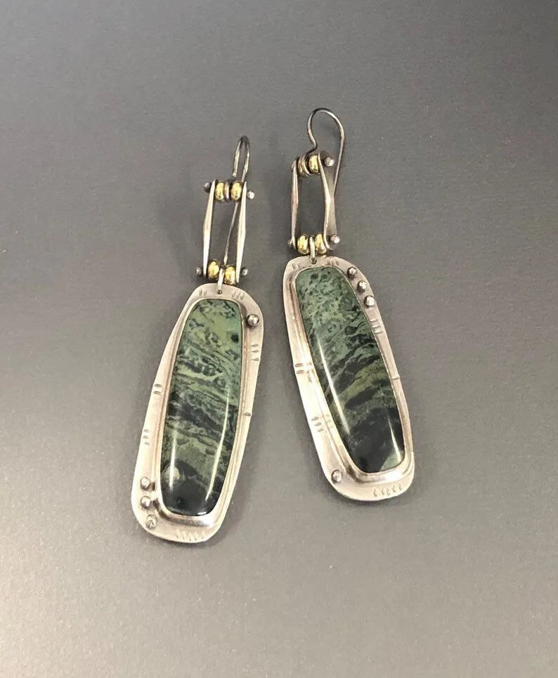 Two-tone geometric marble pattern drop earrings in alloy metal showing contrasting colours