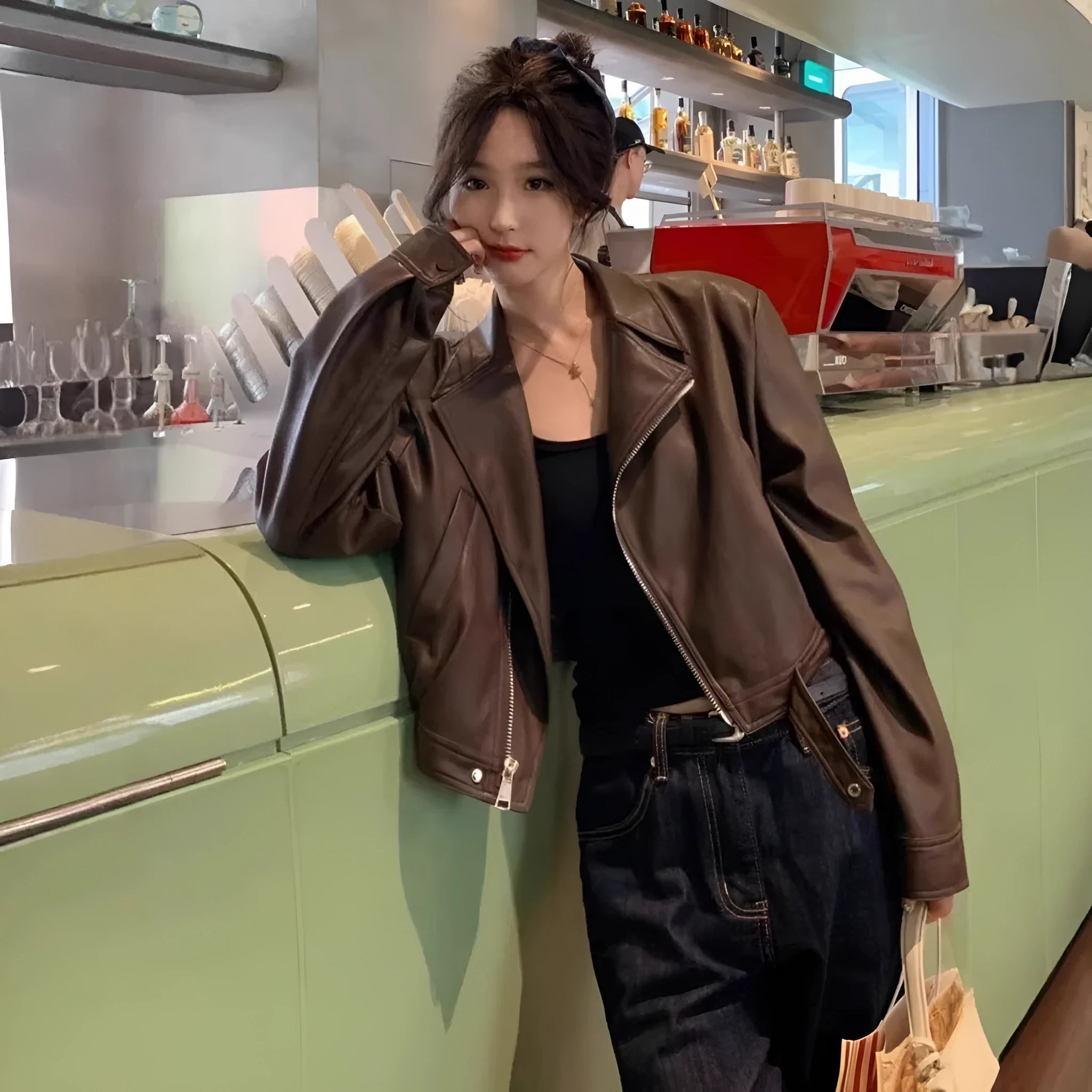 Women's brown retro imitation leather jacket with long sleeves, pockets, and a slim fit.