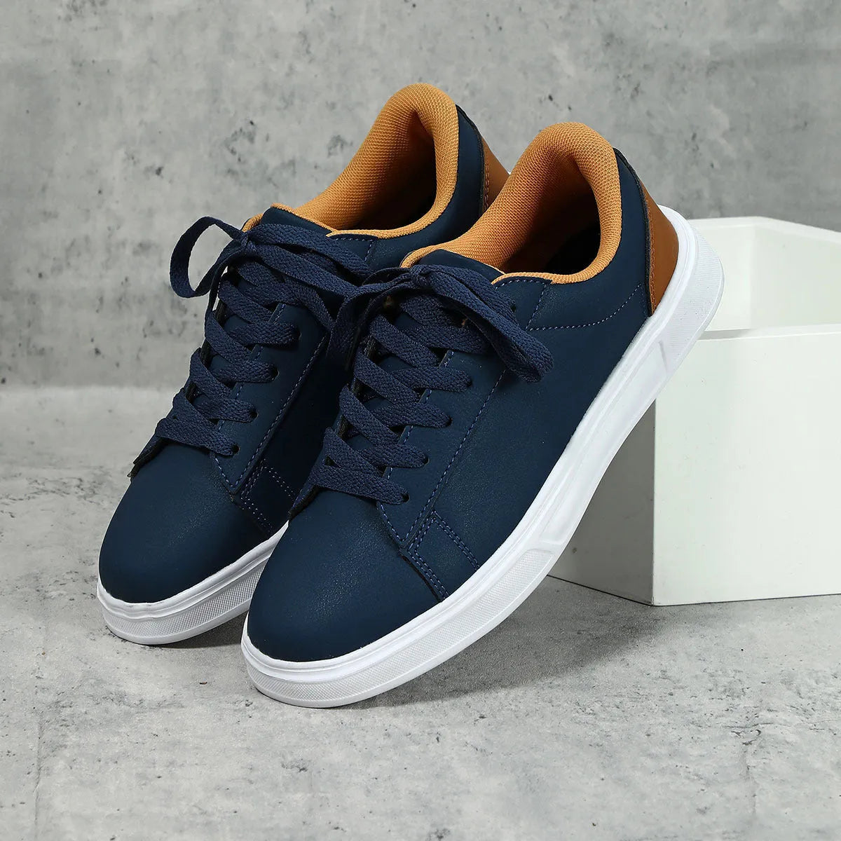 Beige brown platform skateboard sneaker with low top, round toe, and cross-belt design on a white background.