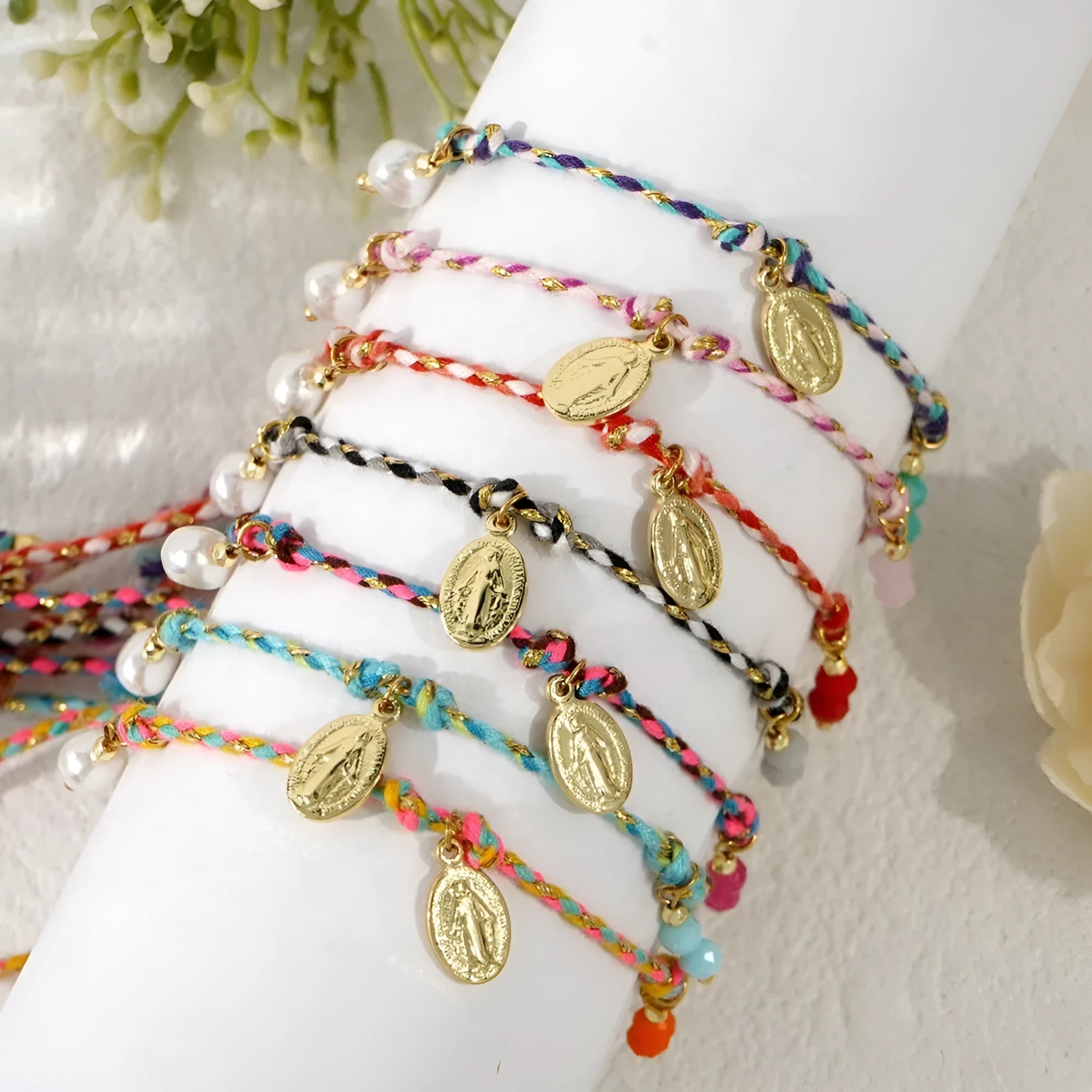 A colourful hand-woven braided rope bracelet with an adjustable strap and tag charm.