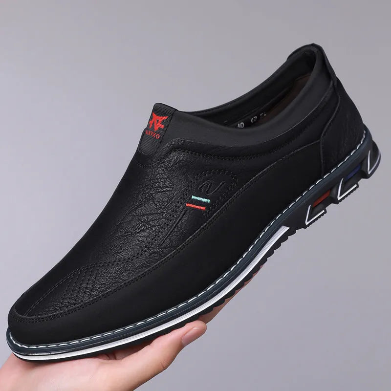 Men's leather slip-on shoes in black, grey, khaki and orange colours with rubber soles and low-top design