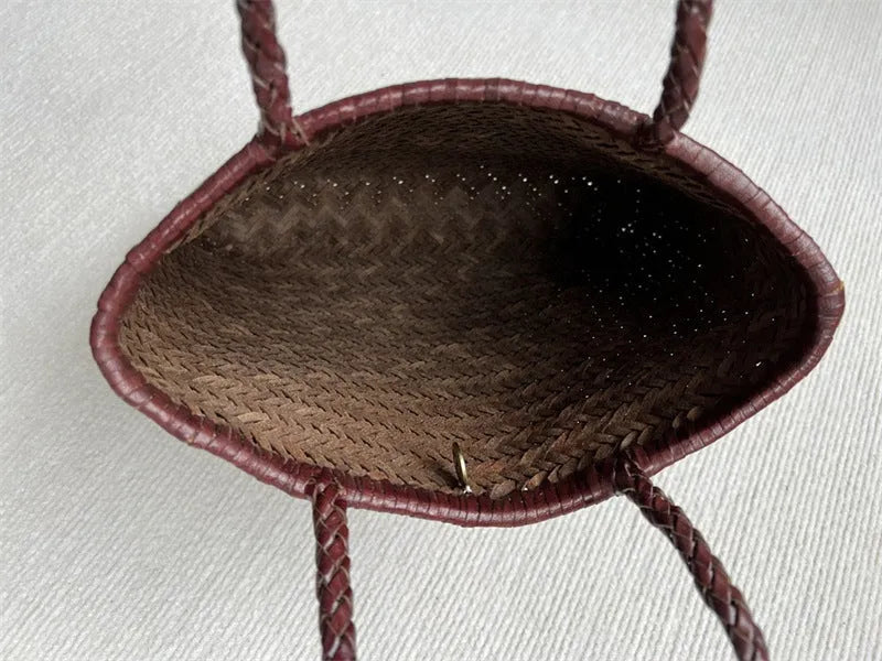 Brown handmade cowhide leather shoulder bag with woven tote design and three-dimensional pocket