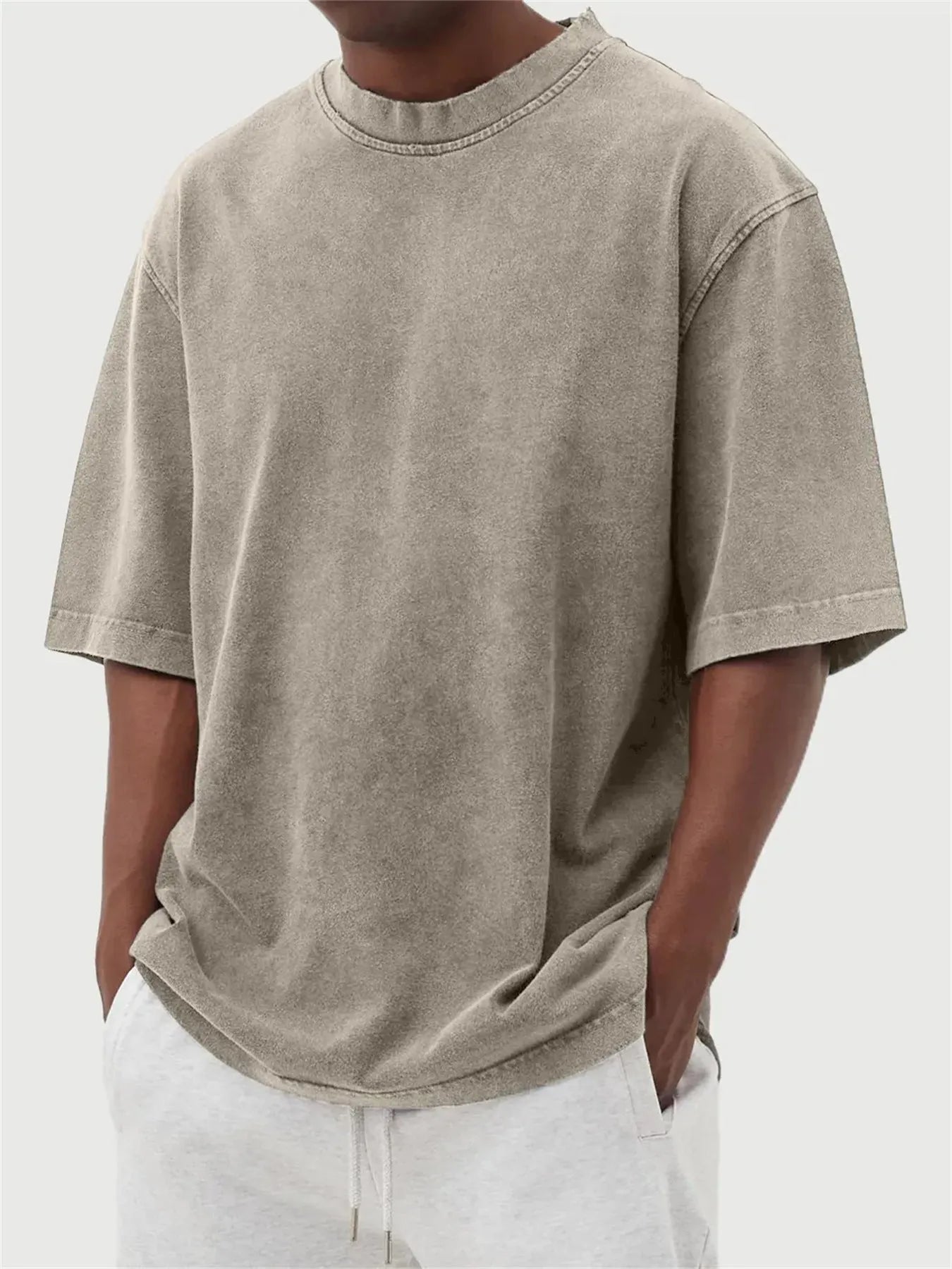 Men's loose-fit stone-washed t-shirt in army green showing distressed texture and pullover style.