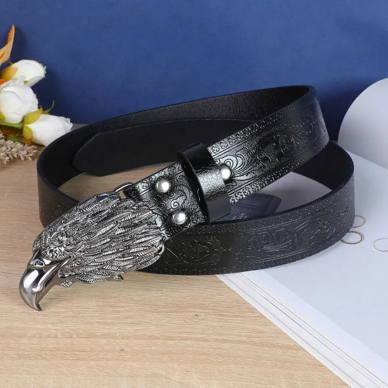 Men's brown leather-look belt with a detailed metal cow head buckle showing carved and embossed details.