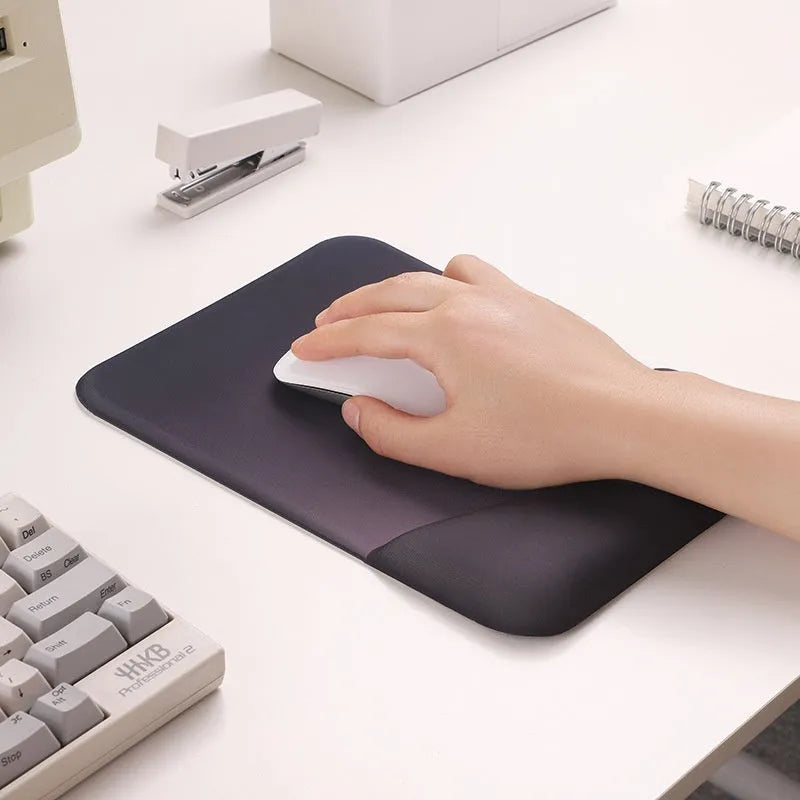 Square black silica gel wrist rest mouse pad on a desk with keyboard